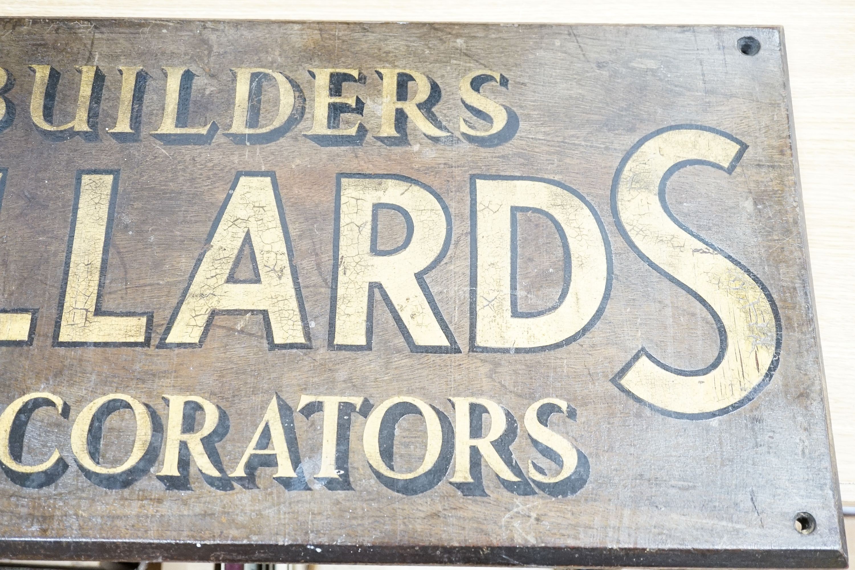 A painted wood advertising sign ‘MILLARDS BUILDERS DECORATORS’, pre war 33x67cm